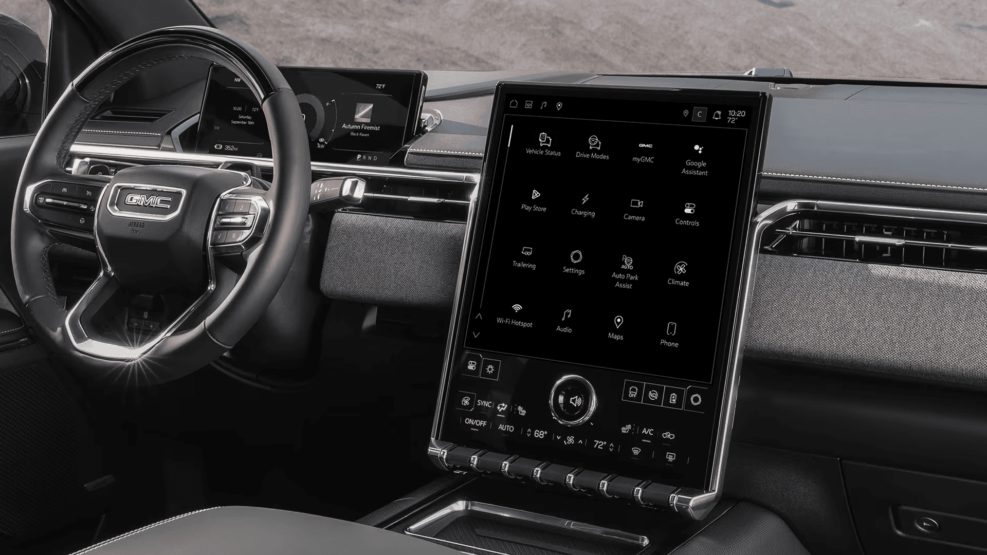 GMC Sierra EV interior with steering wheel, driver display, and tall center touchscreen showing app icons