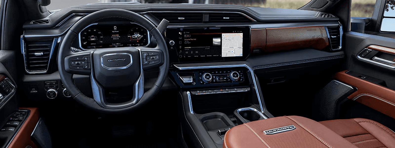 Denali Ultimate interior of the 2026 GMC Sierra HD featuring premium leather seating, wood trim, and full dashboard layout