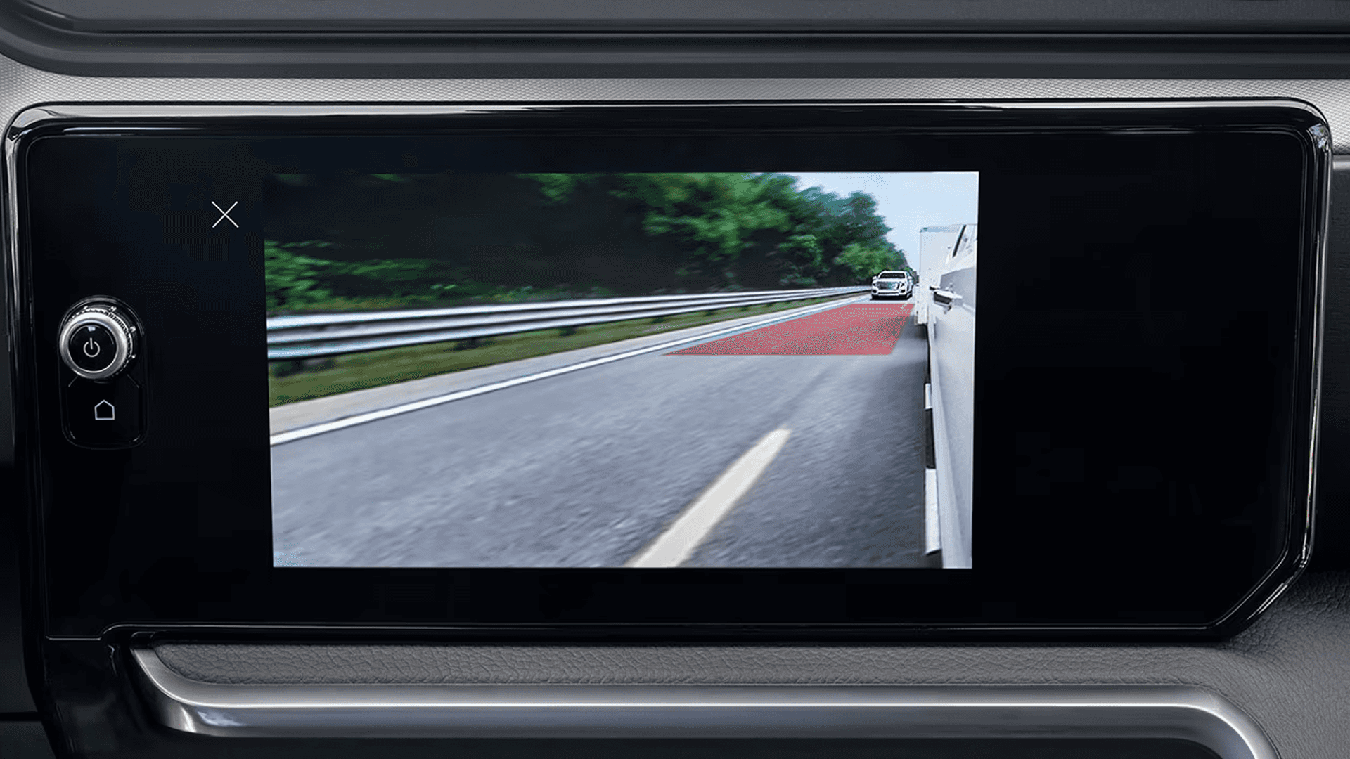 2026 GMC Sierra HD display showing a trailer camera view with a vehicle approaching from behind on the highway.