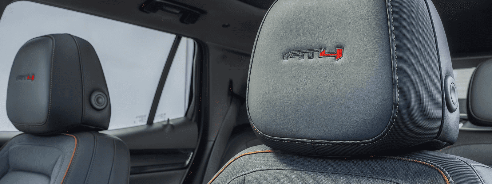 AT4 interior seat of the 2026 GMC Terrain showing headrest logo, contrast stitching, and rugged trim details