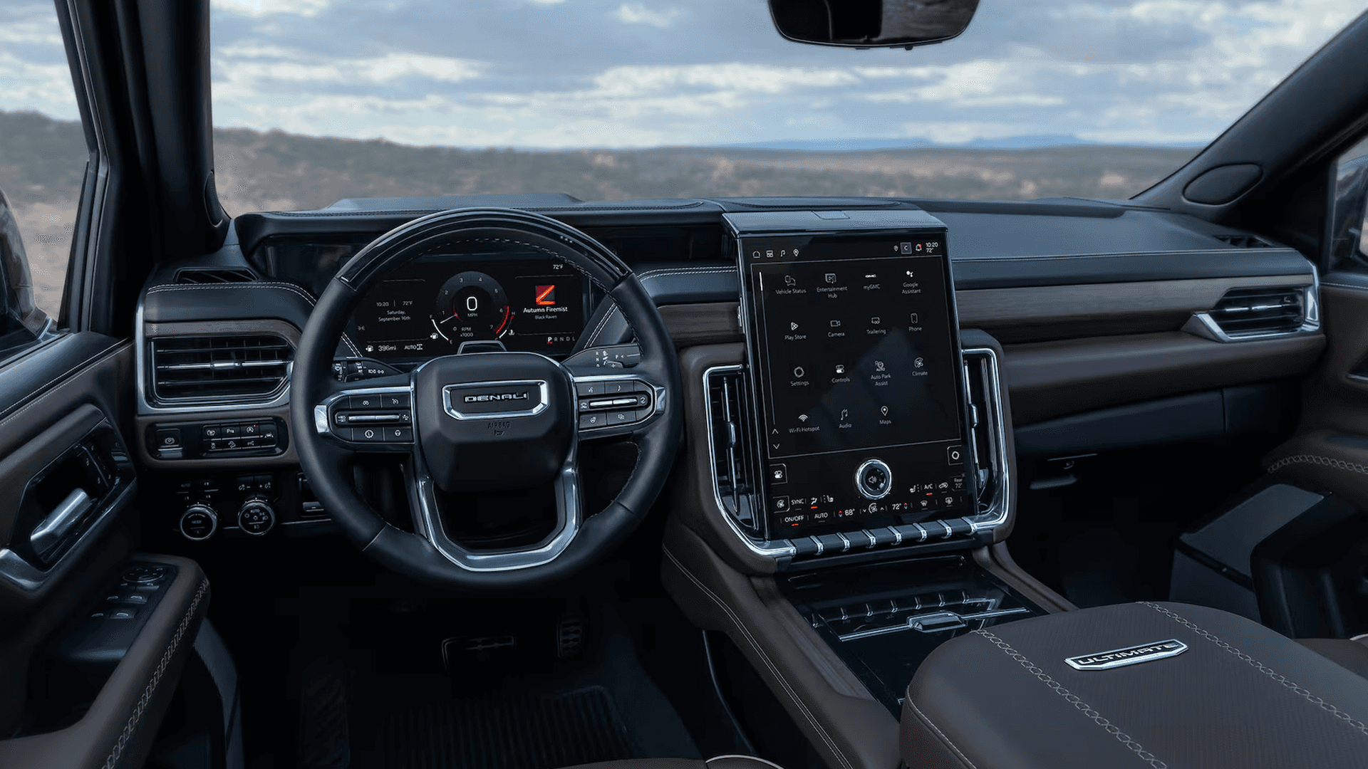 Interior view showing steering wheel, digital gauge cluster, and large vertical center touchscreen display.