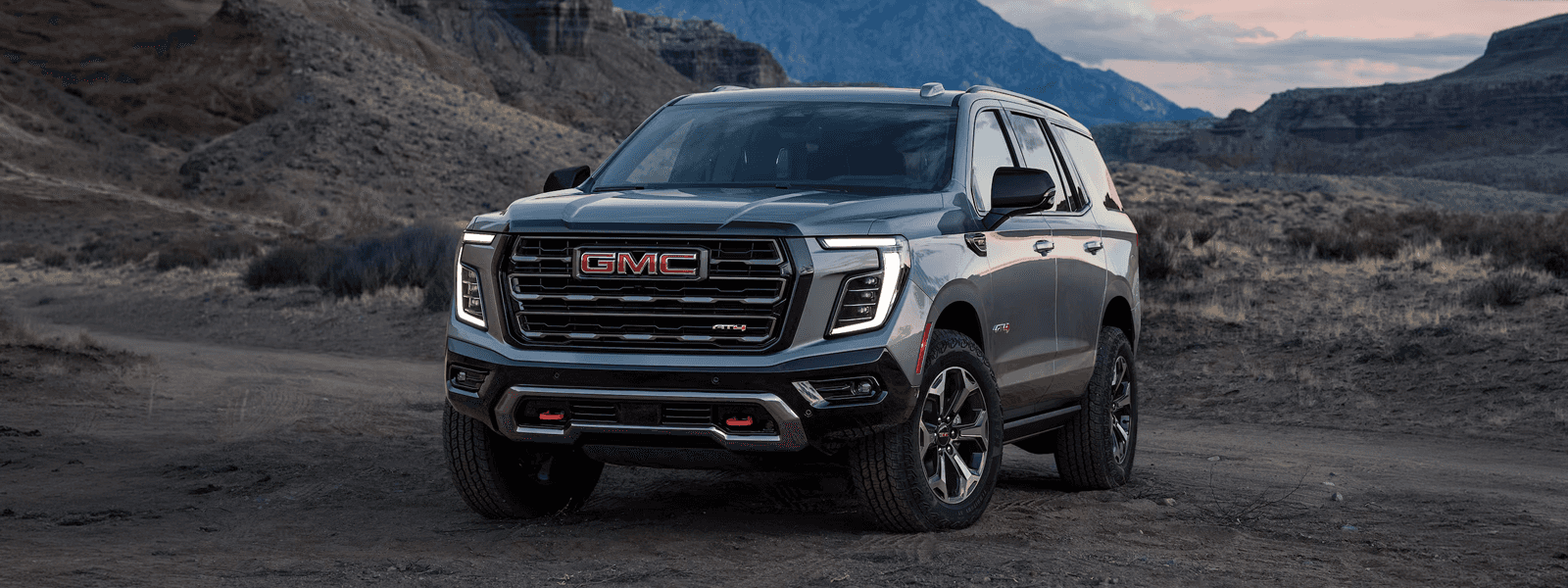 Grey 2026 GMC Yukon in an offroad desert environment