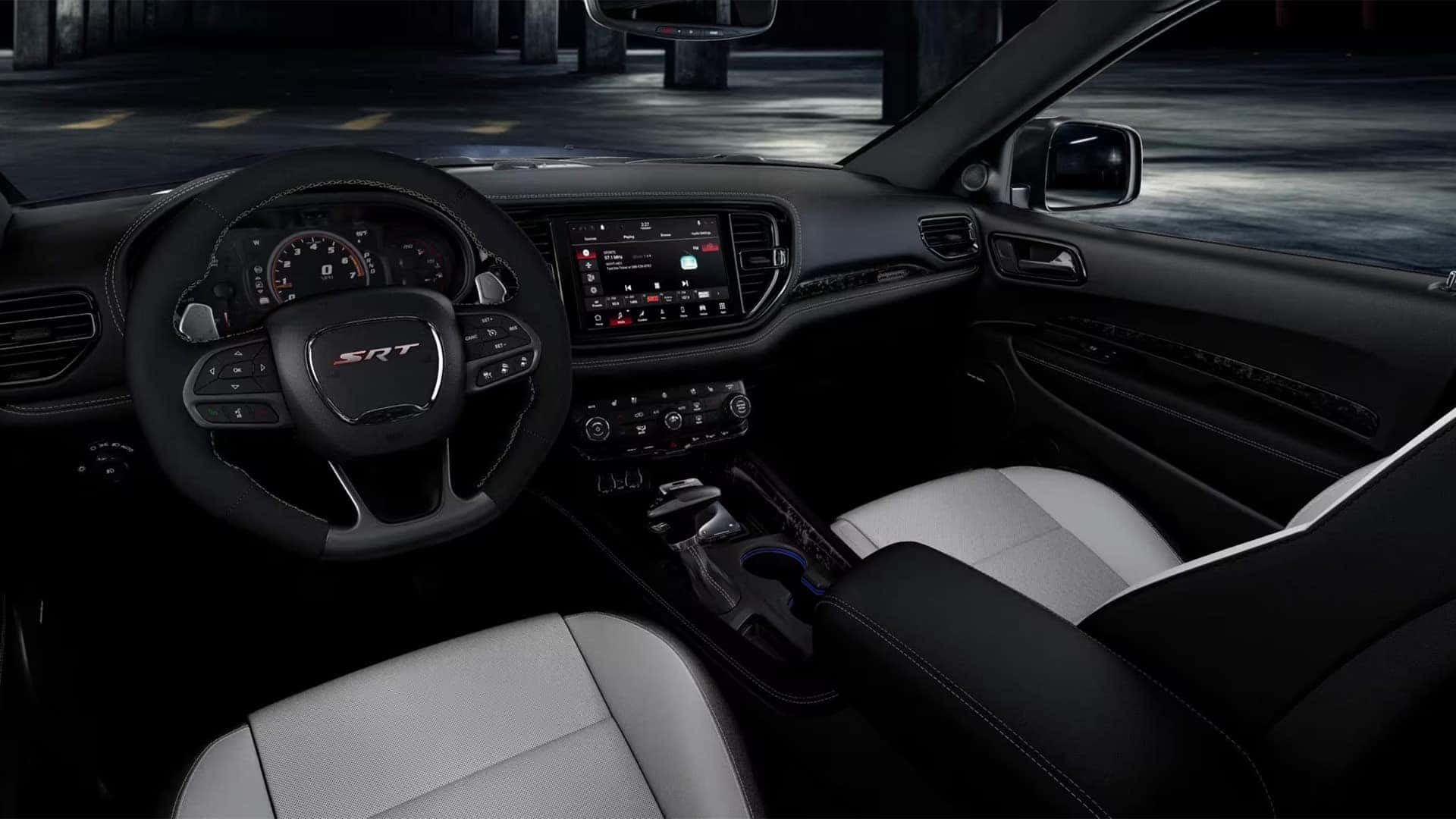 2026 Dodge Durango SRT interior with steering wheel controls, digital gauge cluster, and Uconnect touchscreen display