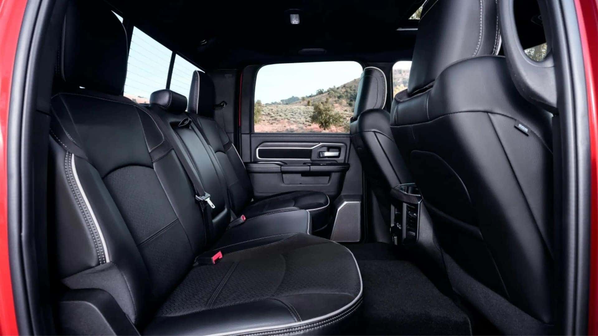 Rear seating area inside the 2026 RAM 2500 crew cab interior with spacious passenger legroom and black upholstery