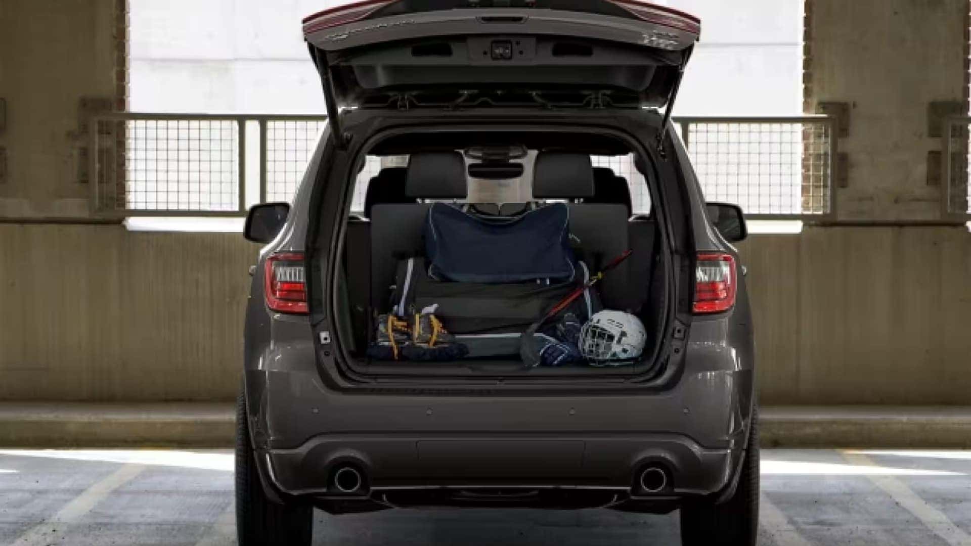 Rear view of the 2026 Dodge Durango with liftgate open showing cargo area loaded with sports gear and equipment