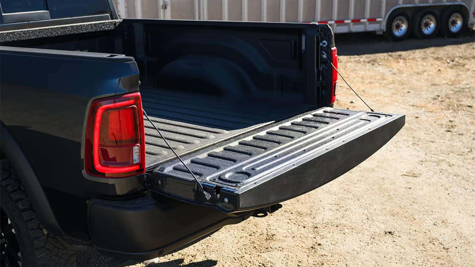 Open tailgate and cargo bed of a 2026 RAM 2500 pickup truck showing textured bed liner and rear taillight