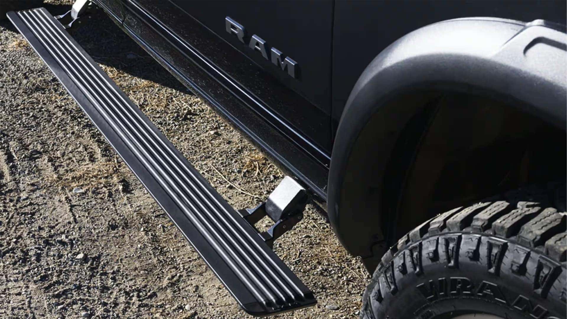 Power running board extended beneath the door of a 2026 RAM 2500 truck for easier cab entry