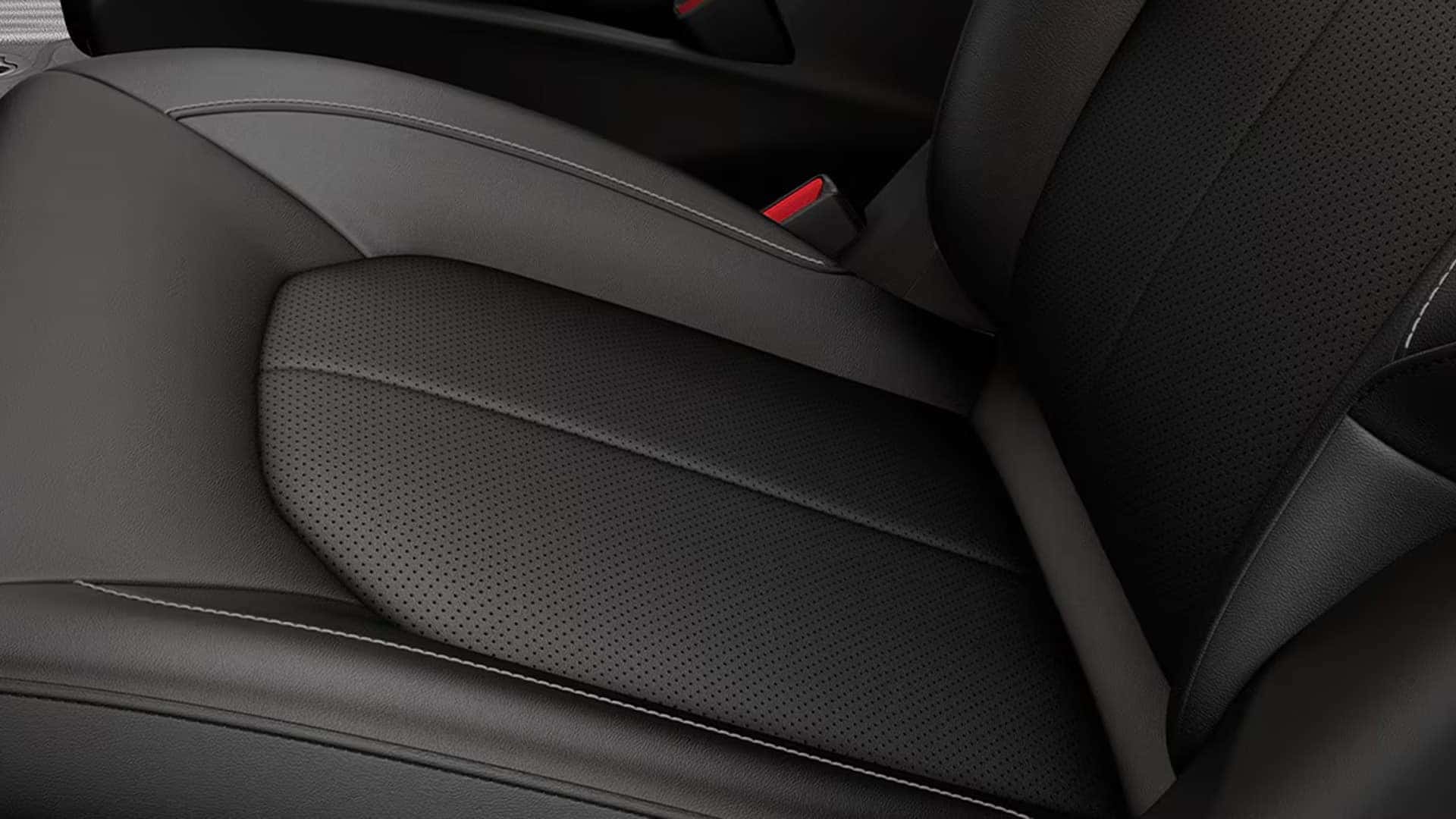 Close-up of black Caprice leatherette seat upholstery inside the 2026 Chrysler Voyager