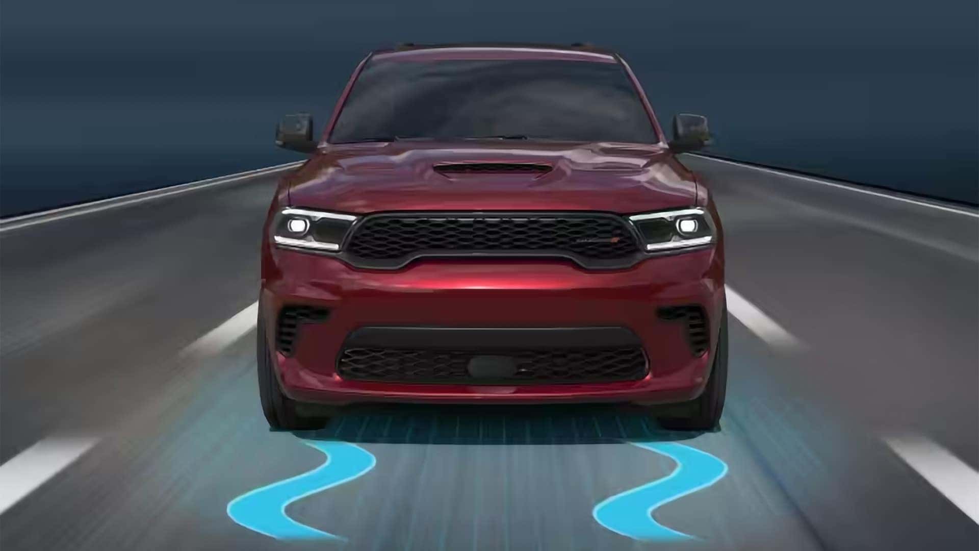2026 Dodge Durango driving forward with stability control graphic illustrating advanced safety and driver assist technology