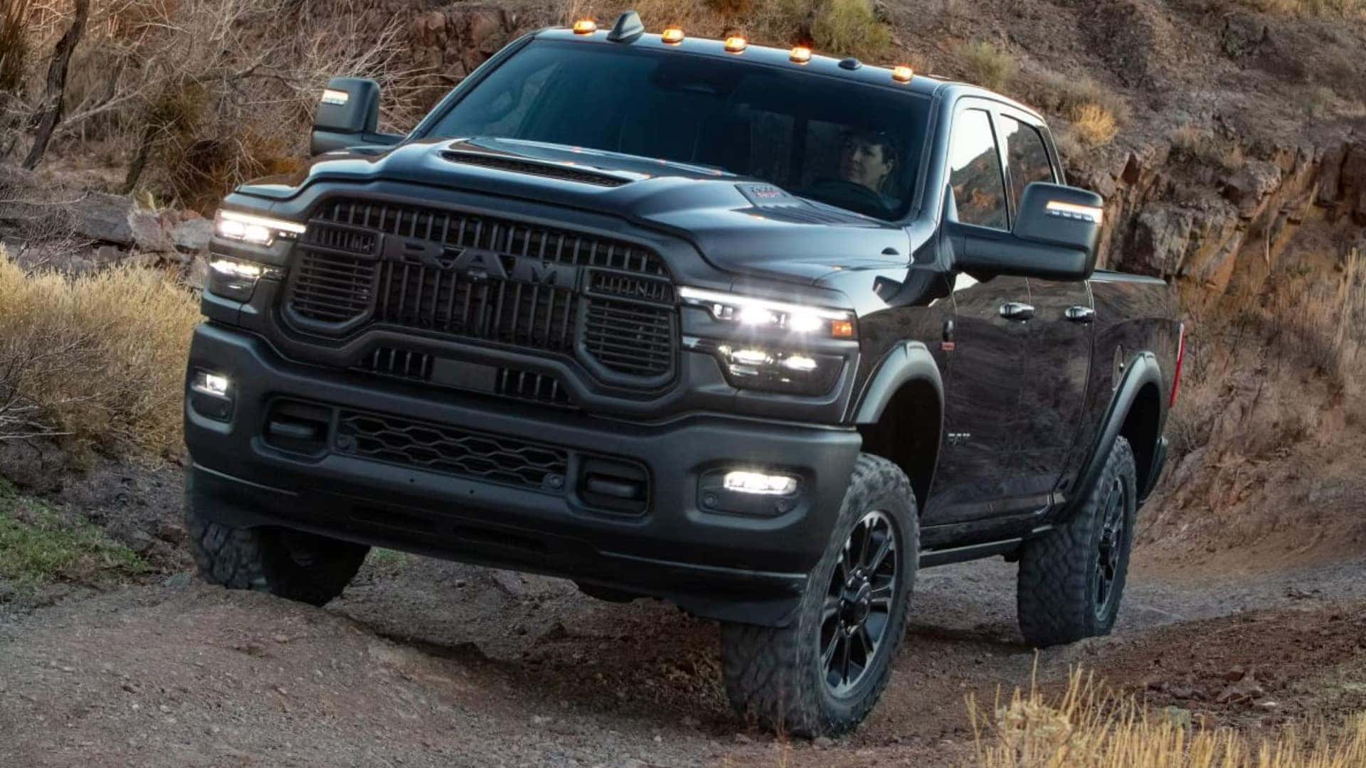 RAM 2500 heavy duty pickup driving off road with raised suspension and aggressive tires highlighting truck capability