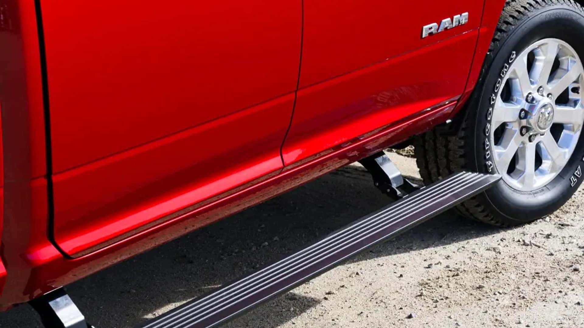 Close-up of the 2026 Ram 3500 front headlight, chrome grille, and towing mirror