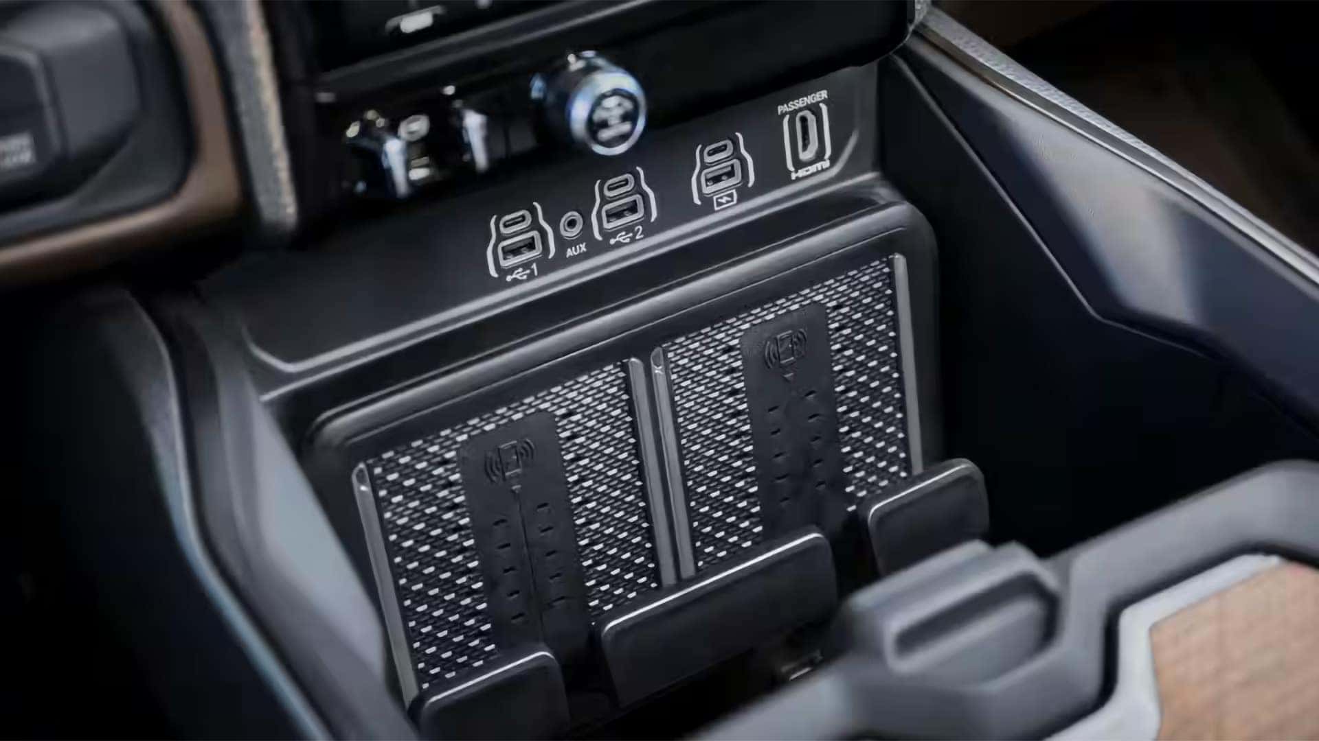 Multiple technology screens inside the 2026 RAM 3500 showing infotainment, navigation, and towing information