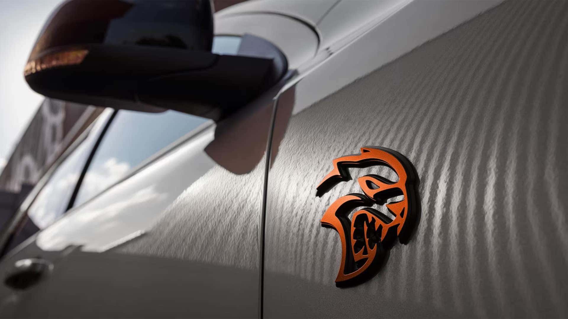 Close-up of the Dodge Durango SRT Hellcat badge on the front fender showing the high-performance trim emblem.