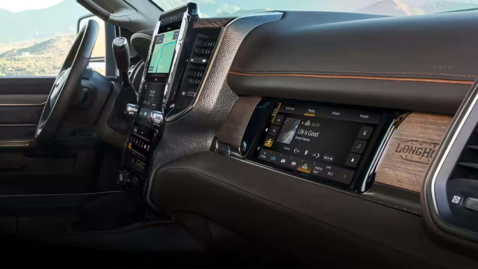 Premium interior technology in the 2026 RAM 3500 featuring large touchscreen infotainment system and passenger display