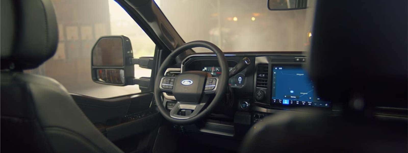 Front interior of the 2026 Ford F-350 Super Duty showing steering wheel, digital display, and center touchscreen
