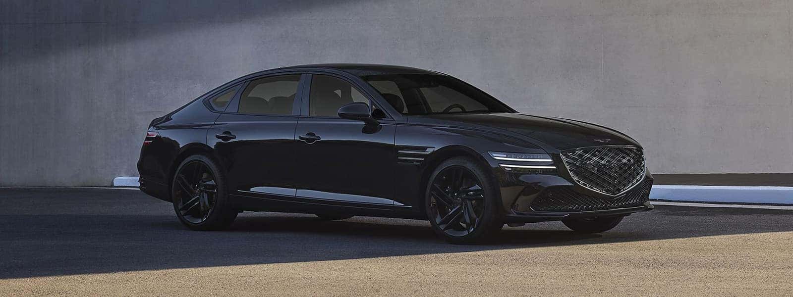 Black 2026 Genesis G80 luxury sedan parked on pavement showing full exterior profile and sleek body design