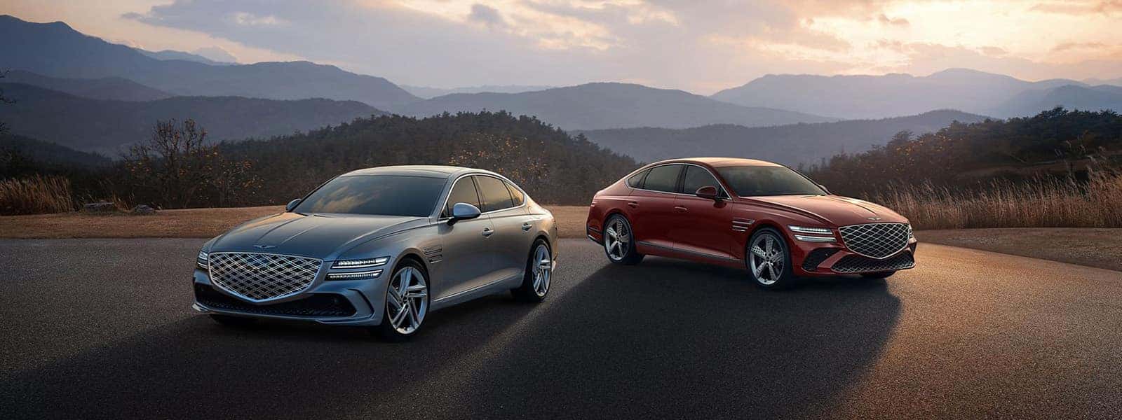 2026 Genesis G80 luxury sedans parked on a mountain overlook at sunset