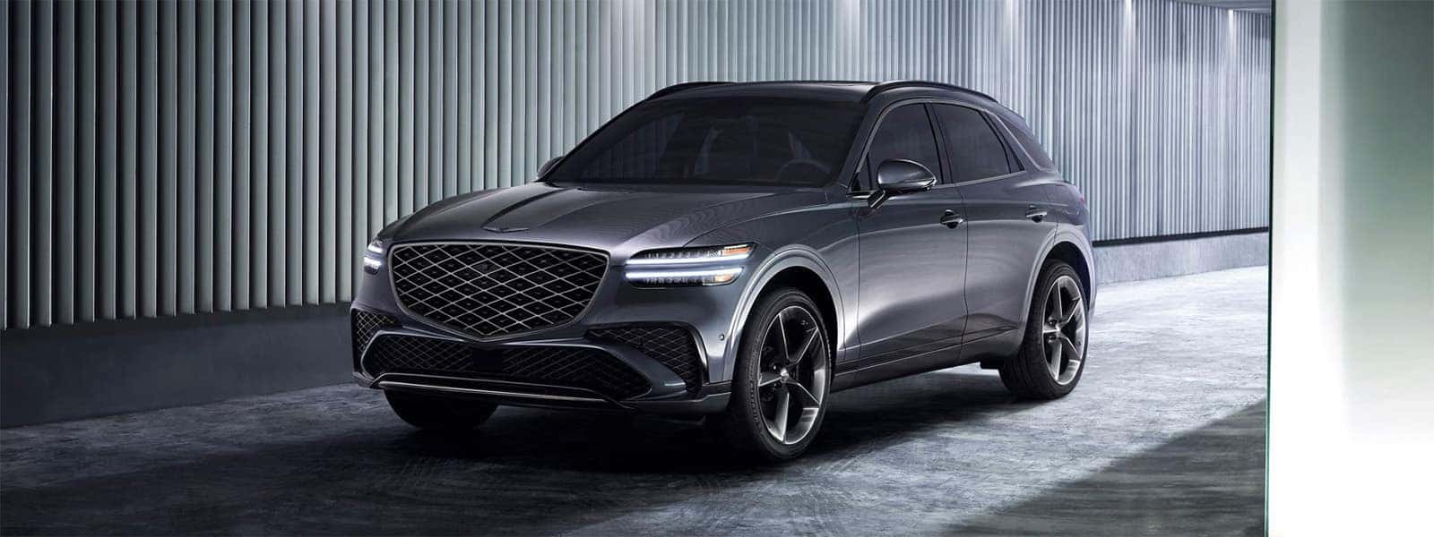 2026 Genesis GV70 luxury SUV parked in a modern setting with athletic exterior styling and signature grille