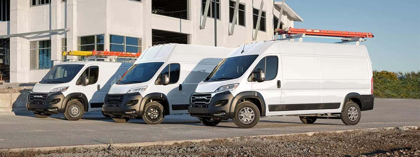 2026 RAM ProMaster Cargo Van lineup parked at a jobsite with multiple work van configurations shown