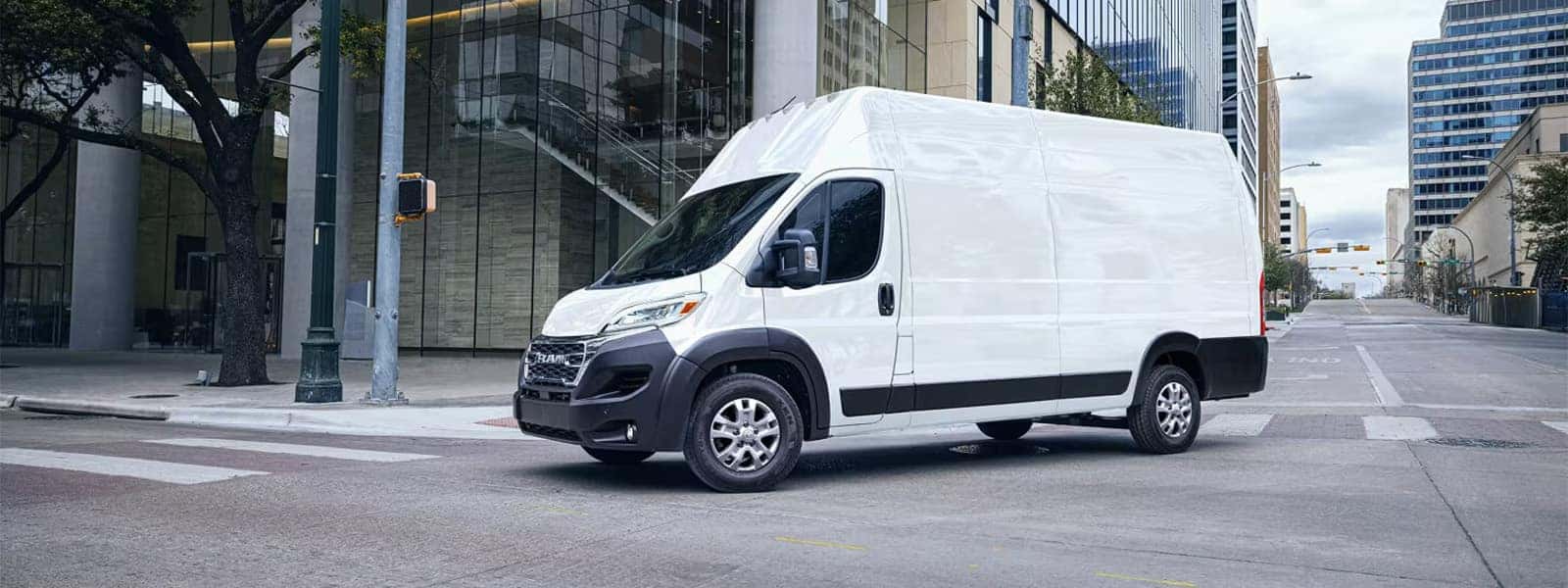 2026 RAM ProMaster Cargo Van in white driving through downtown city streets