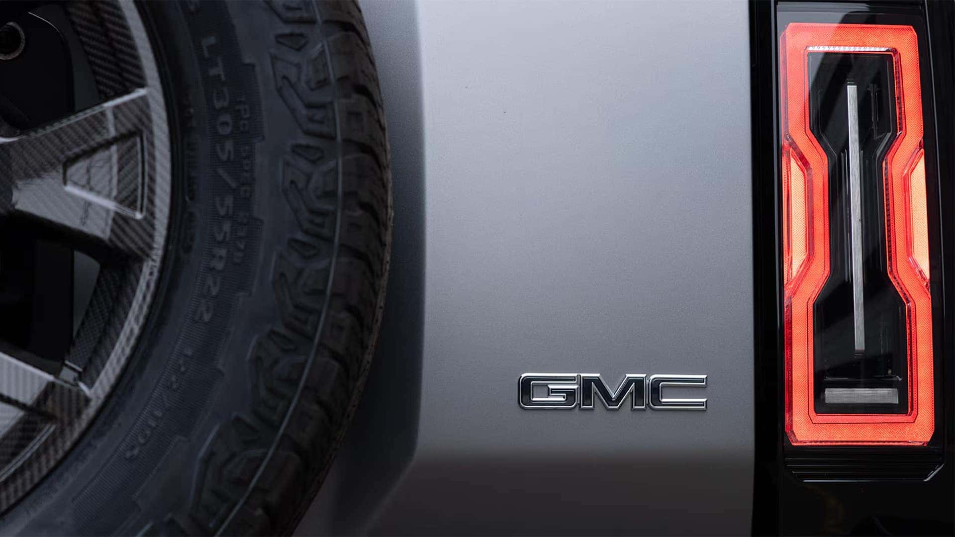 2026 GMC HUMMER EV SUV rear close-up with GMC badge and LED taillight design detail