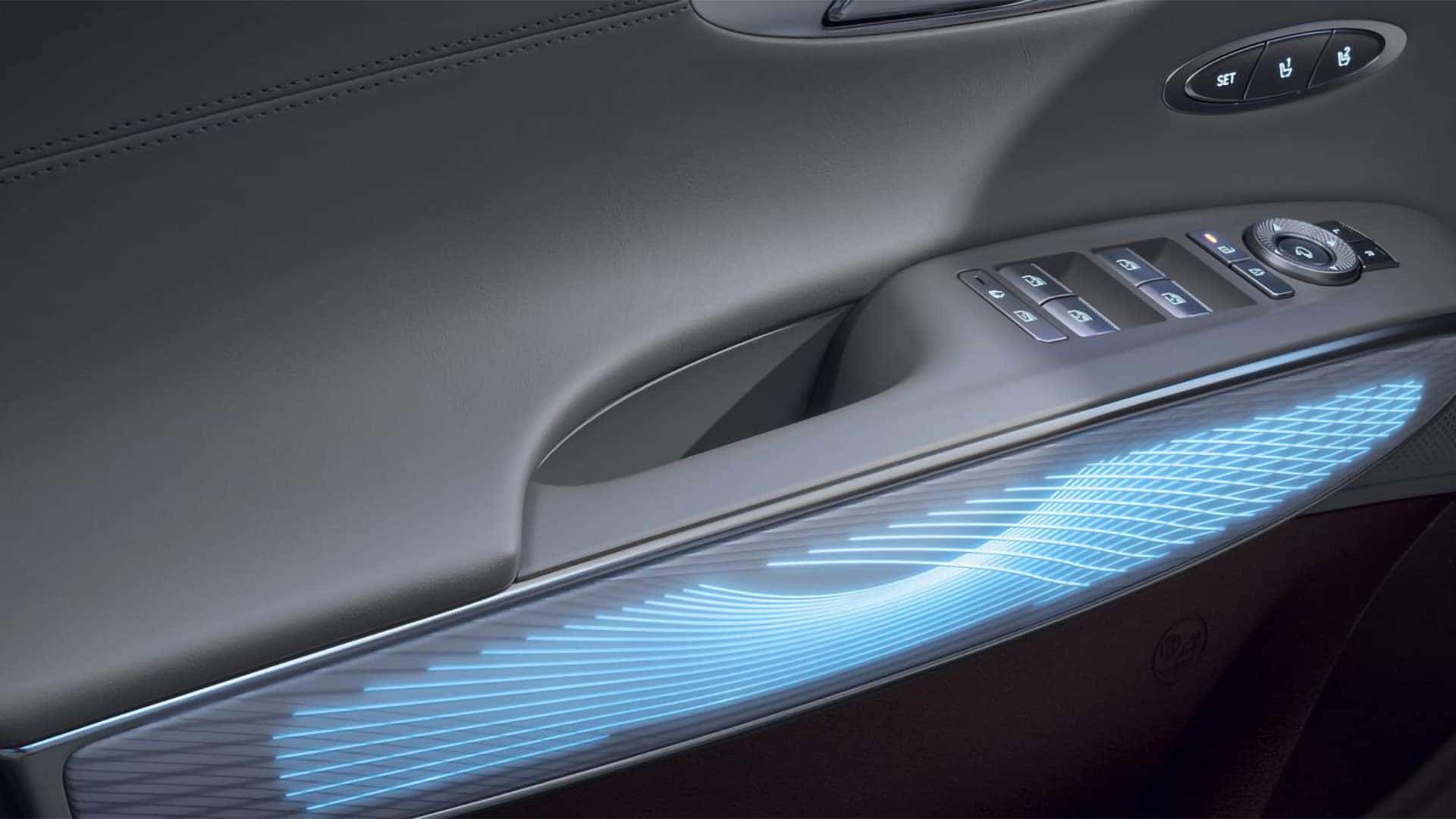 2026 Genesis GV70 illuminated interior door trim with power window controls, seat memory buttons, and ambient lighting
