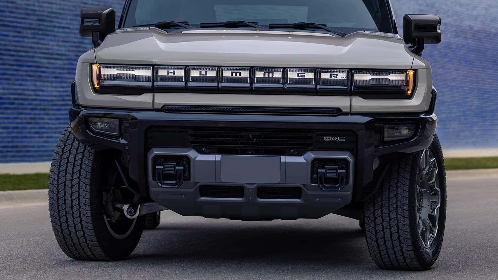Front view of 2026 GMC HUMMER EV SUV highlighting signature lighting, bold grille design, and wide stance