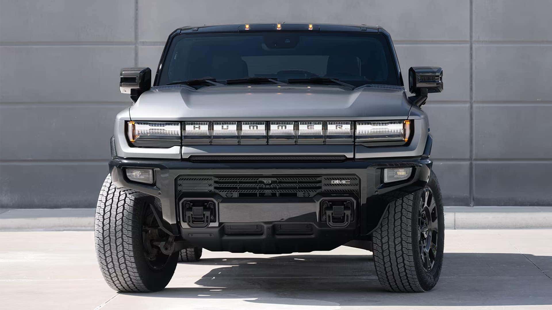 Front view of the 2026 GMC HUMMER EV SUV with signature LED light bar, rugged grille, and wide off-road stance