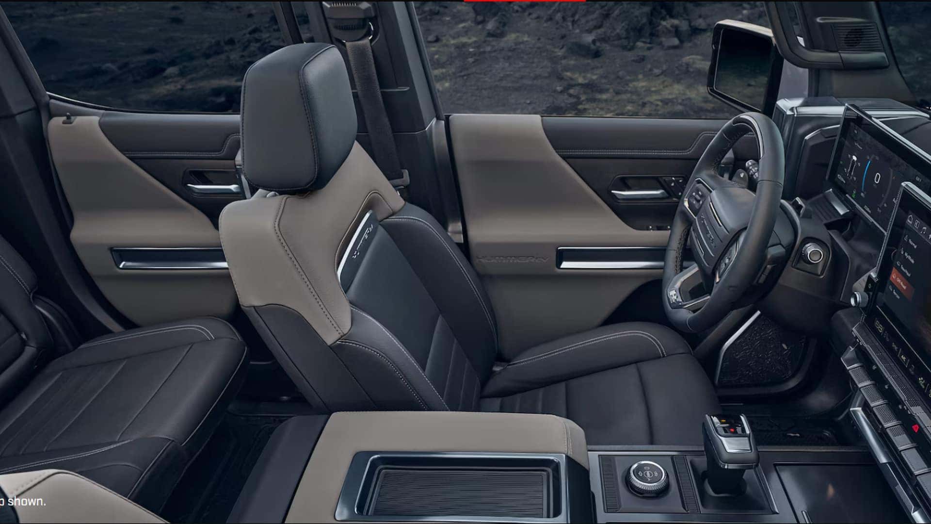 2026 GMC HUMMER EV SUV interior side view showing front seats, center console, and driver cockpit layout