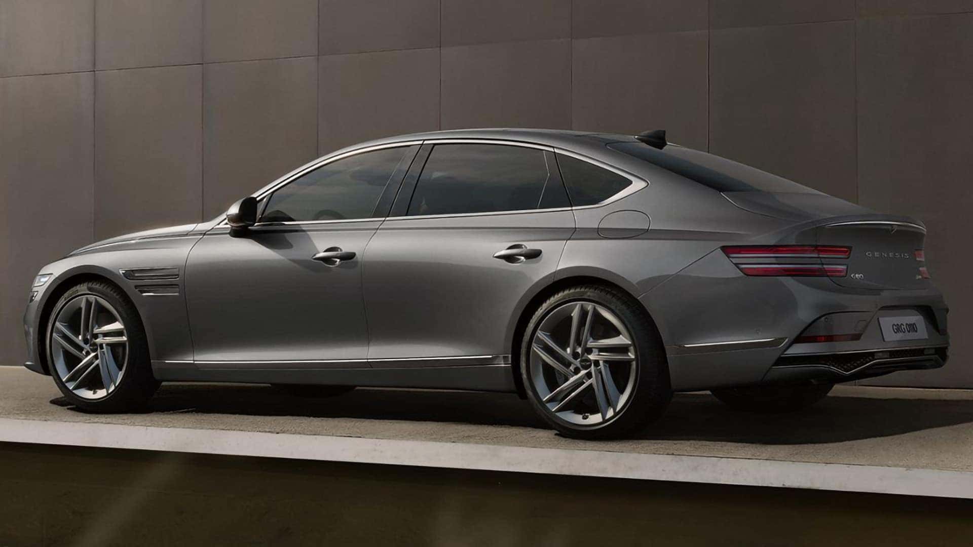 2026 Genesis G80 midsize luxury sedan side profile in gray with alloy wheels and sleek body lines