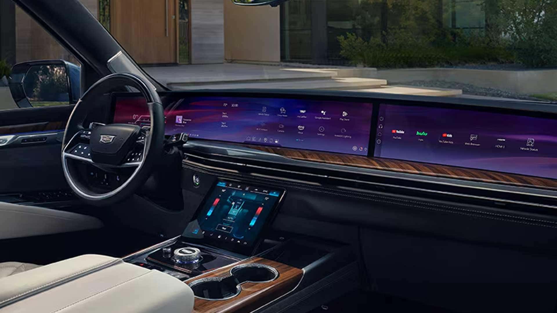 Cadillac Escalade dashboard with a wide digital display, steering wheel, and center controls