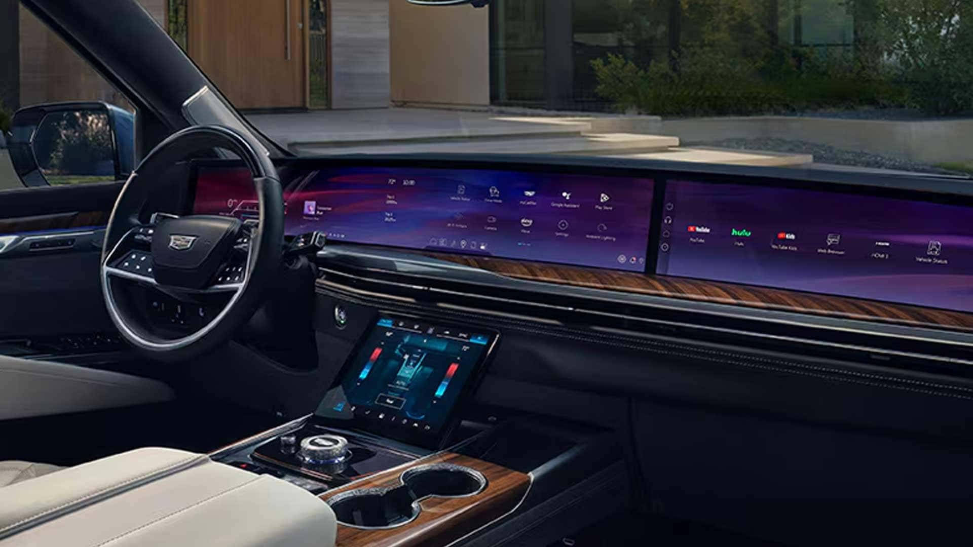 Cadillac Escalade dashboard with steering wheel, wide digital display, and center controls