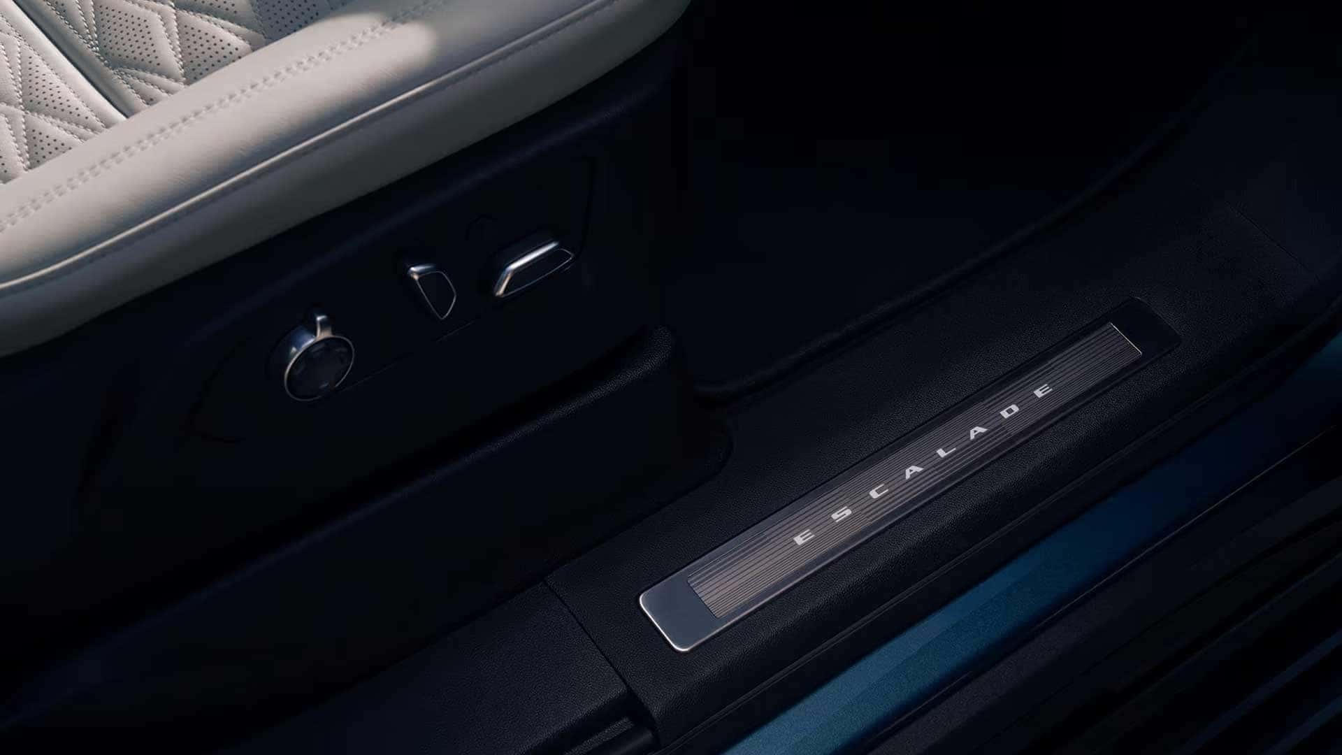 Escalade front seat base with power controls and illuminated door sill plate