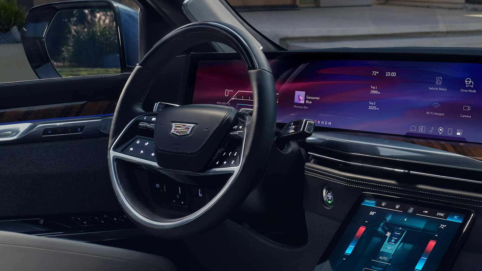 Interior view with steering wheel, wide curved dashboard display, and center touchscreen showing climate controls