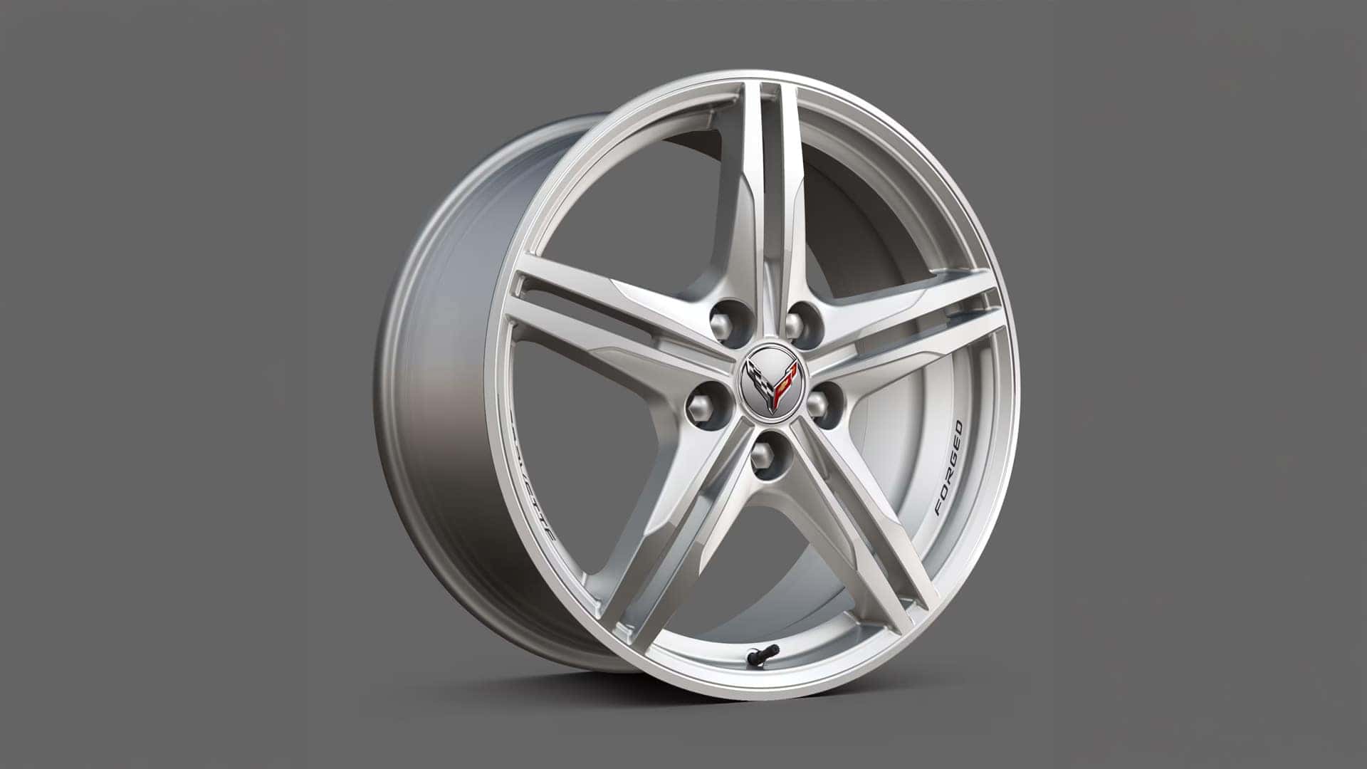 Silver Corvette forged wheel shown against a gray background with Corvette center cap.