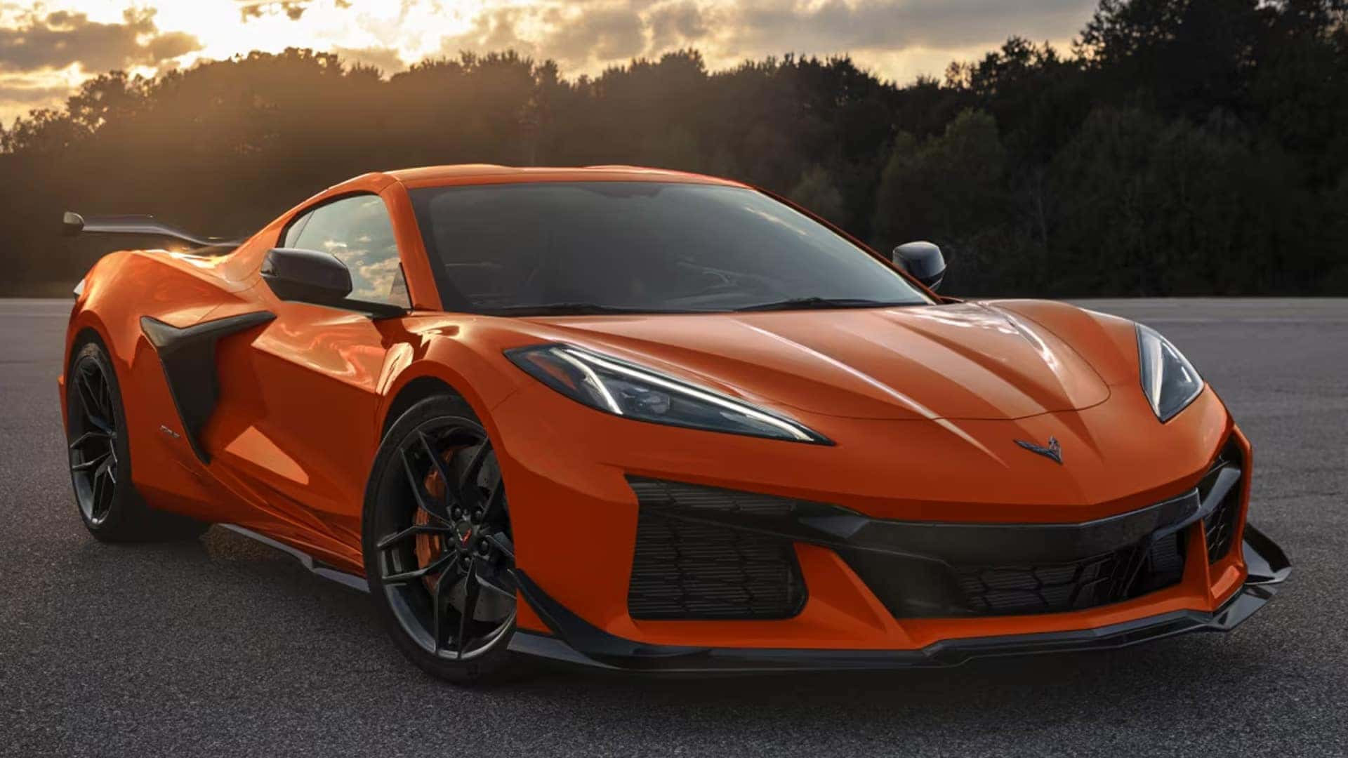 Orange Corvette shown from the front with black wheels, side intake, low front fascia, and rear wing.