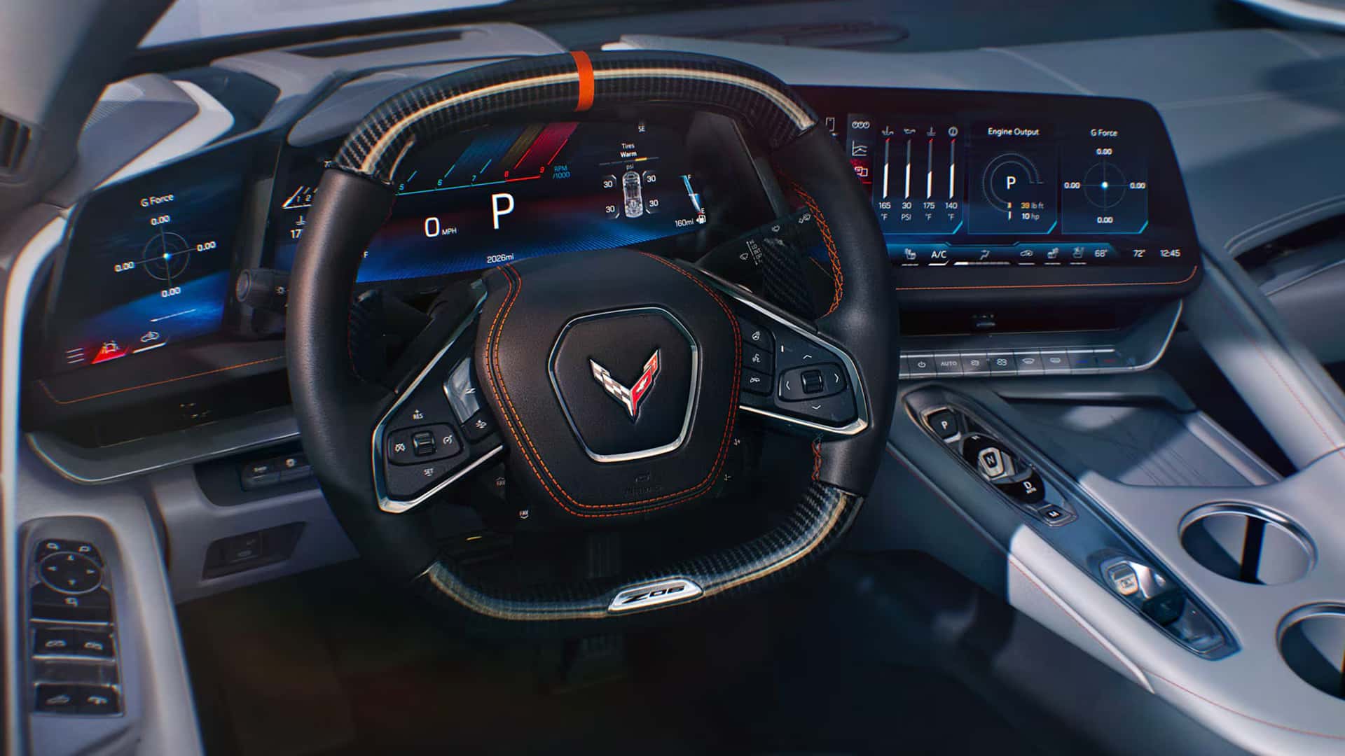 Driver-facing cockpit view of the 2026 Corvette Z06 showing the carbon fiber steering wheel with Z06 badge, auxiliary display, driver information center, and center touchscreen.
