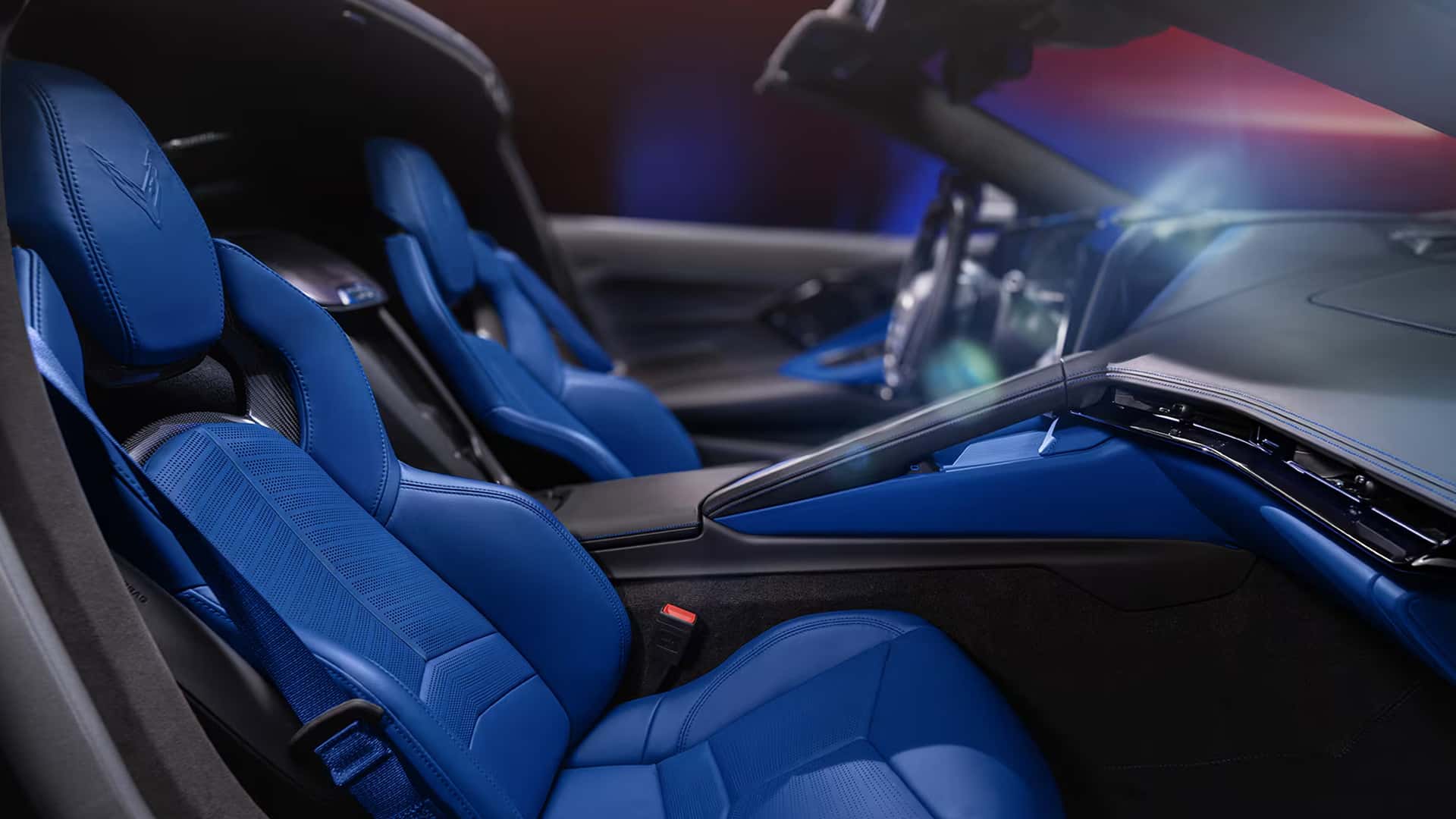 Interior view of the 2026 Corvette Z06 convertible showing both sport bucket seats wrapped in Santorini Blue leather with the black center console visible.