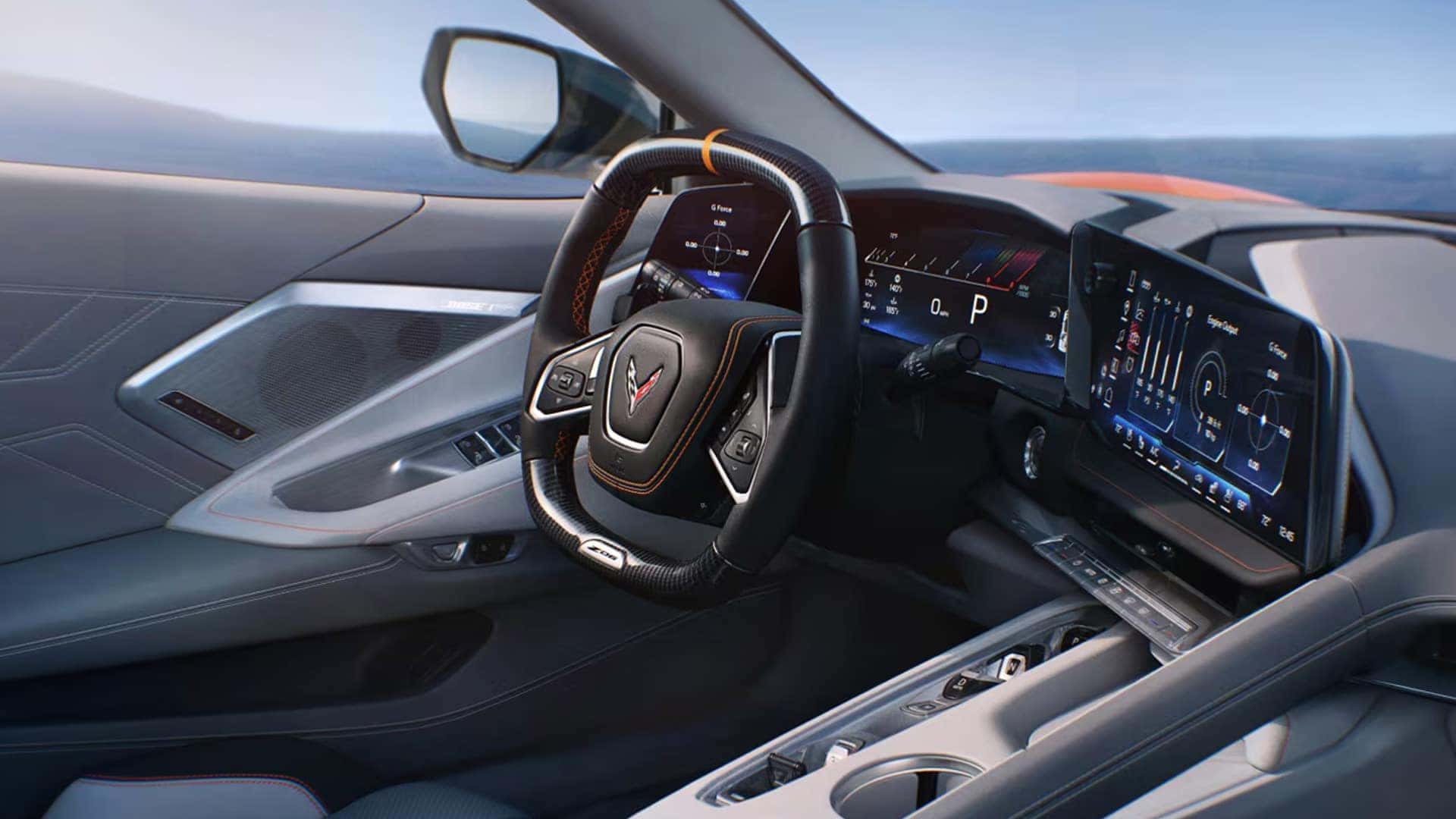 Wide interior view showing a steering wheel, digital gauges, touchscreen, door panel, and cupholders.