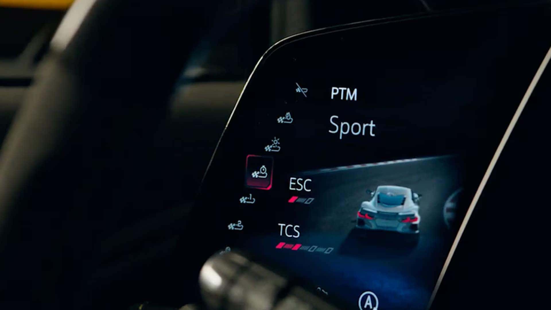 Close-up display showing PTM Sport mode, ESC and TCS bars, and a small vehicle graphic.