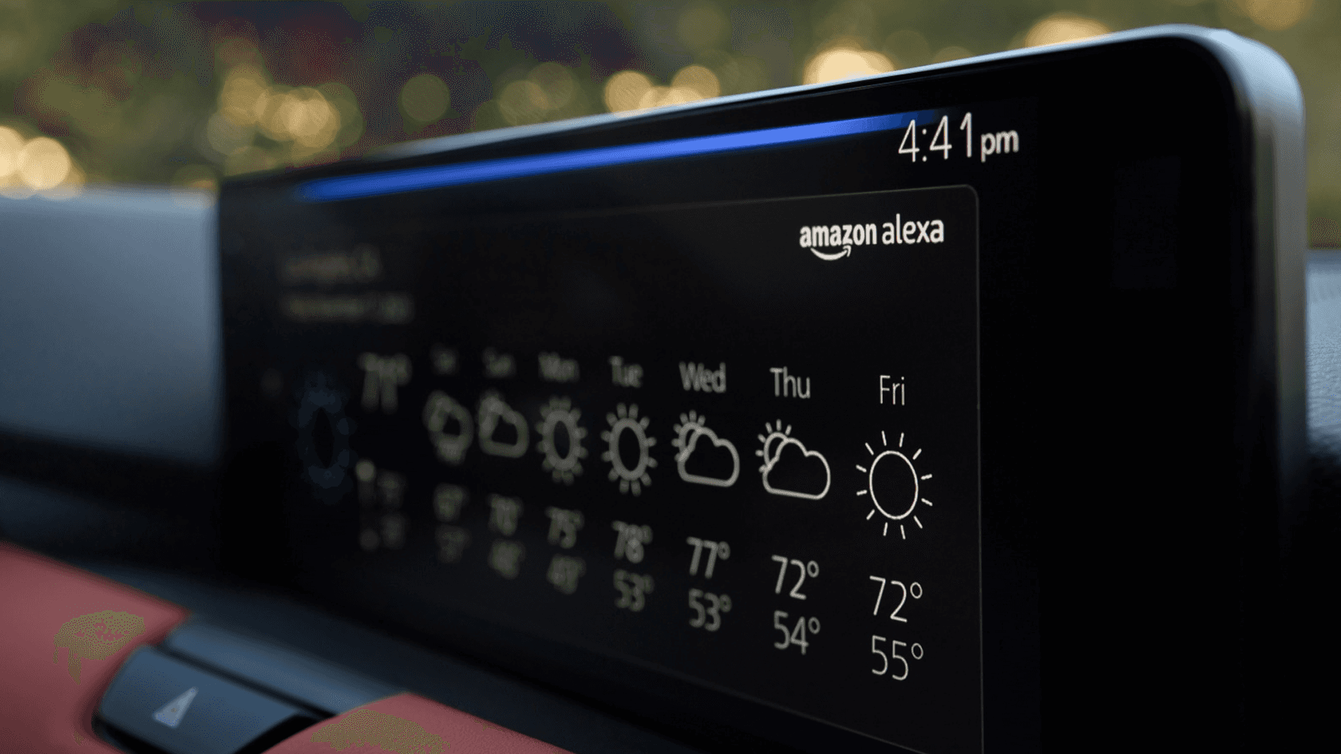 Close-up of a wide dashboard display showing weather icons, temperatures, time, and Amazon Alexa branding