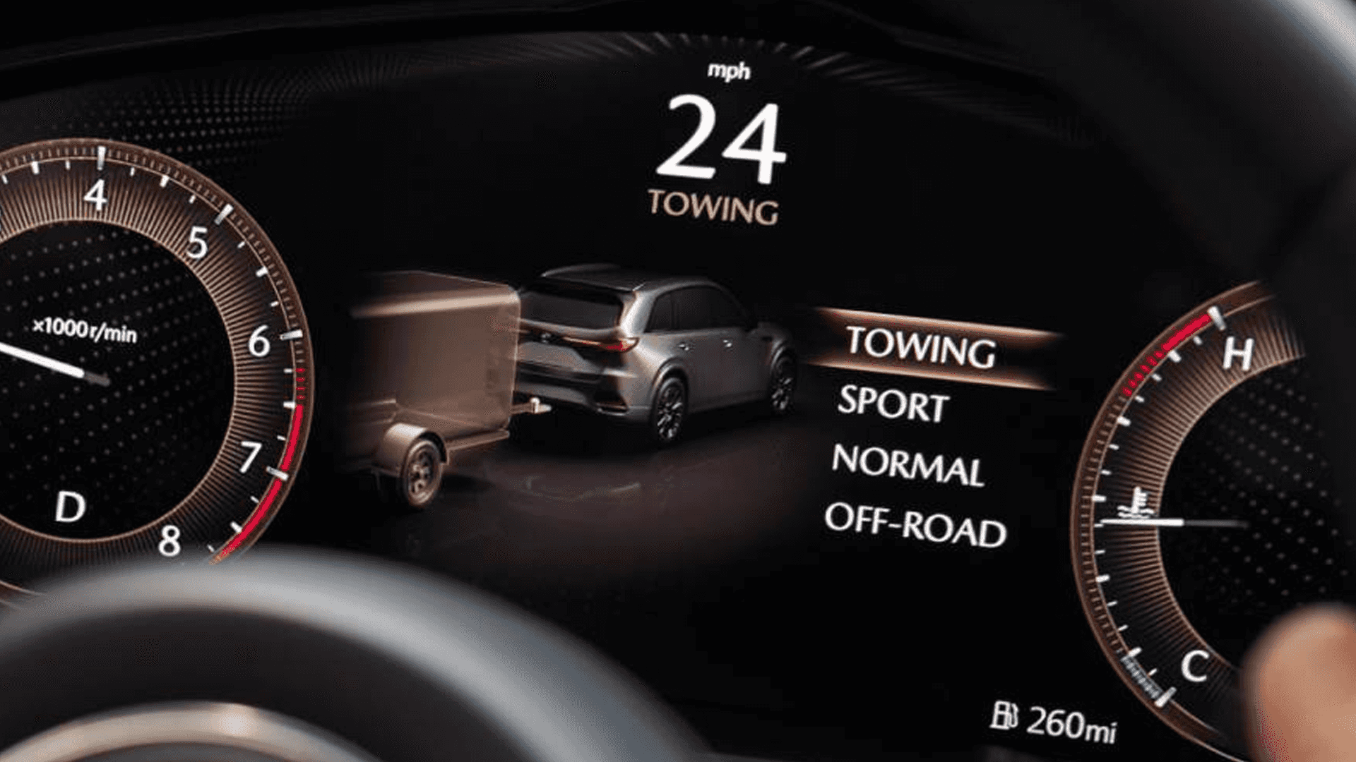 Digital gauge cluster showing Towing mode selected with a vehicle and trailer graphic on the center display