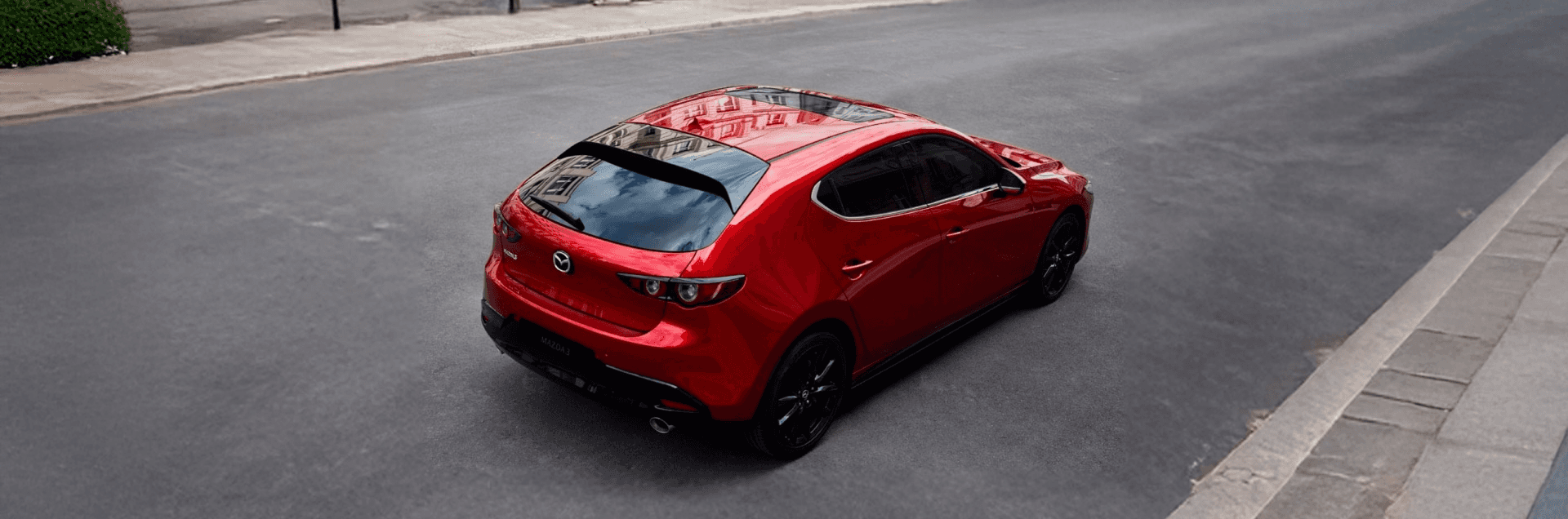 2026 Mazda3 Hatchback 2.5 Turbo Premium Plus in red, front three quarter exterior view