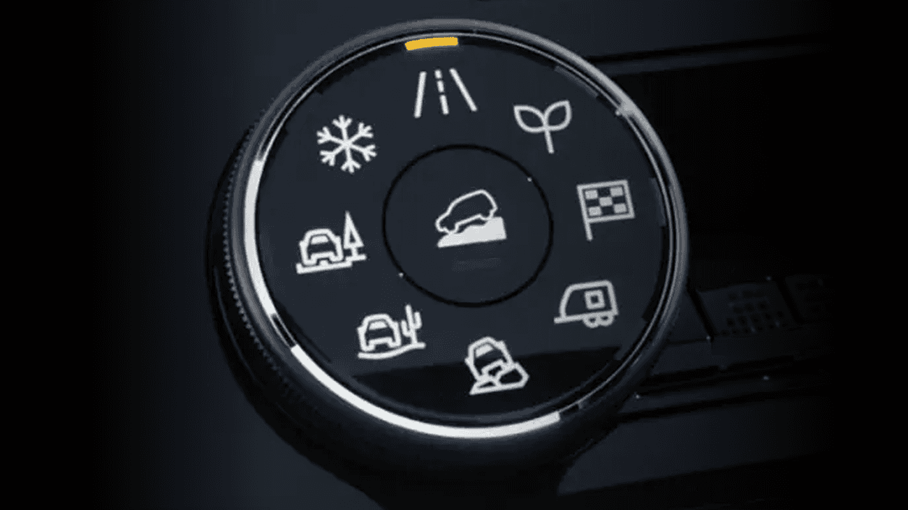 Close-up of drive mode selector dial with icons for snow, road, off-road, and towing settings