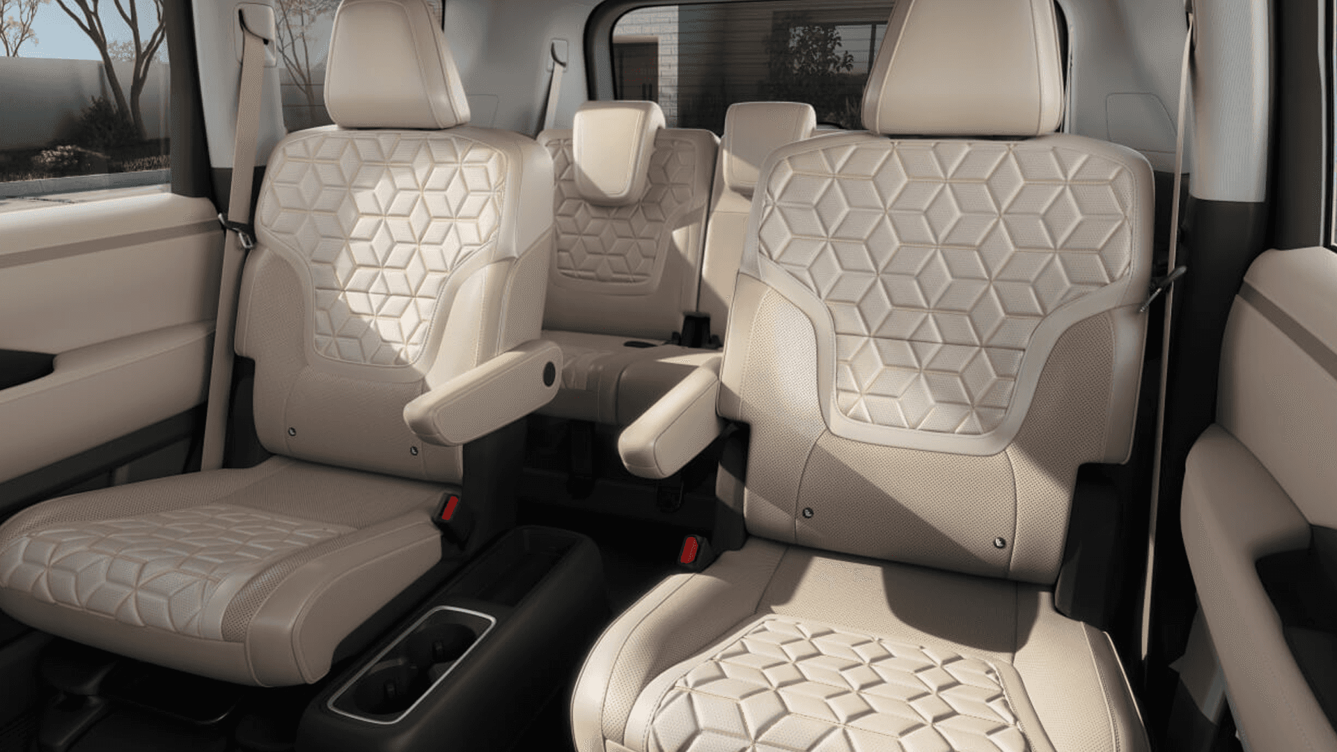 Second-row captain’s chairs with armrests and third-row bench seat in light-colored patterned upholstery