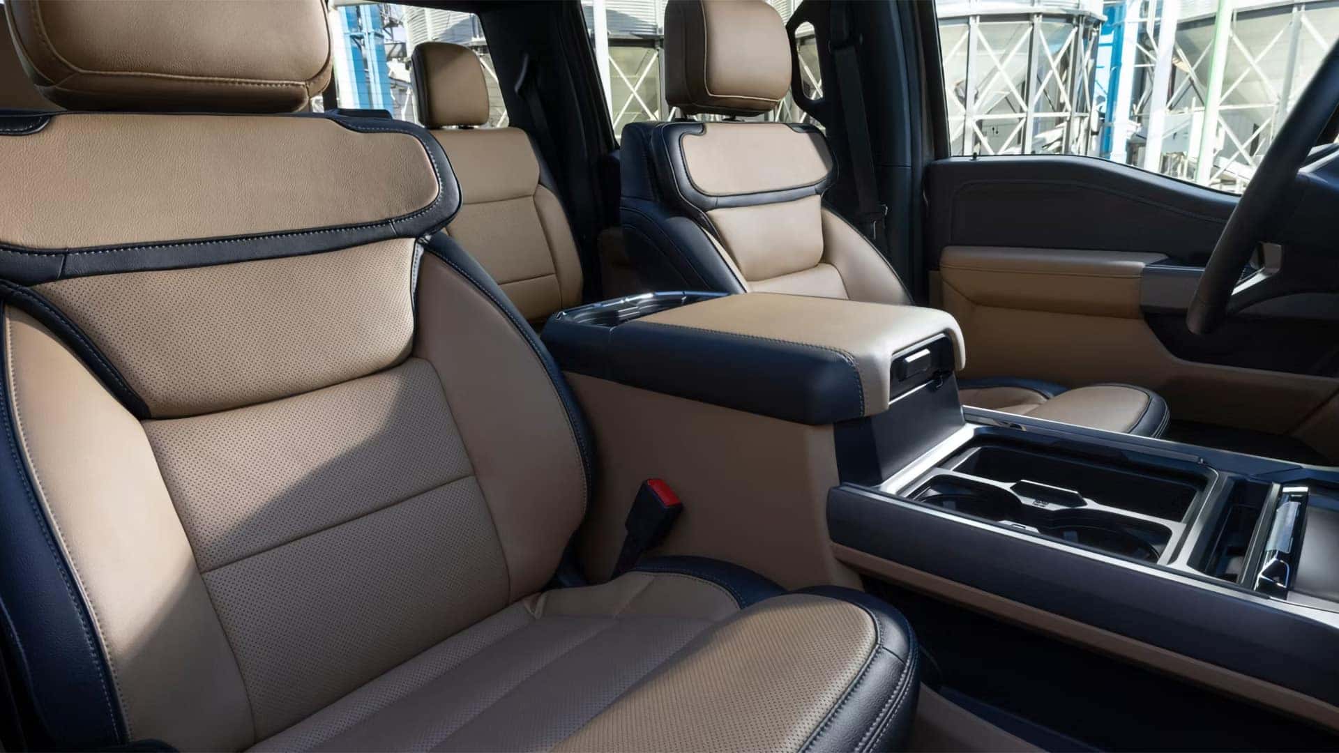 Front seating area of the 2026 Ford F-350 Super Duty with two-tone leather seats, center console, and spacious heavy-duty truck interior