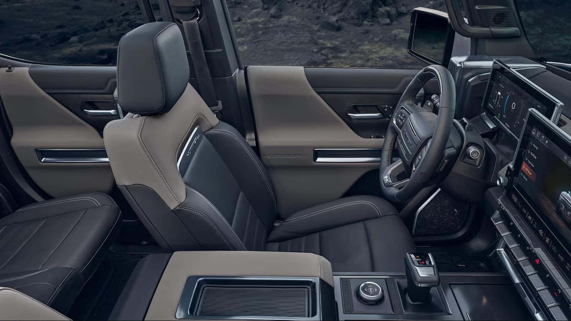 2026 GMC HUMMER EV SUV interior with premium front seats, center console, and modern electric SUV cabin layout