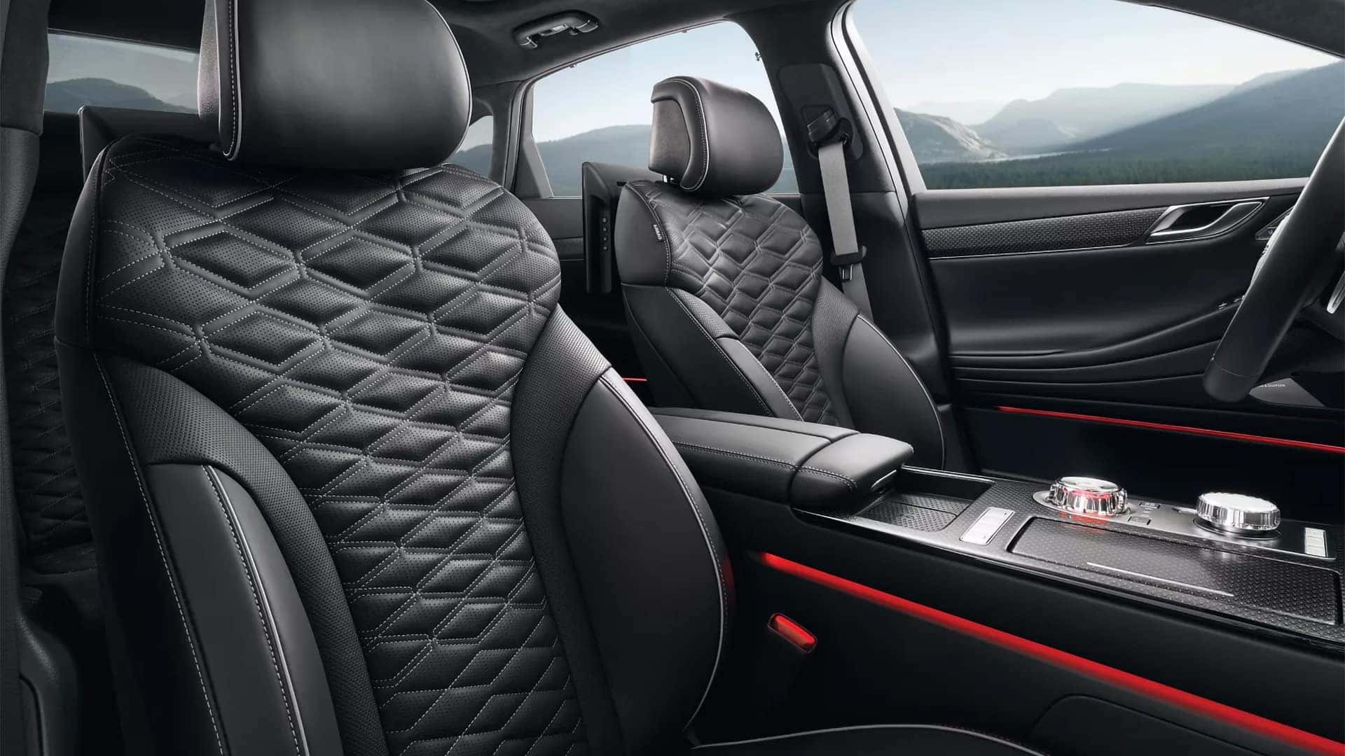 2026 Genesis G80 interior showing quilted leather front seats, center console, and ambient lighting