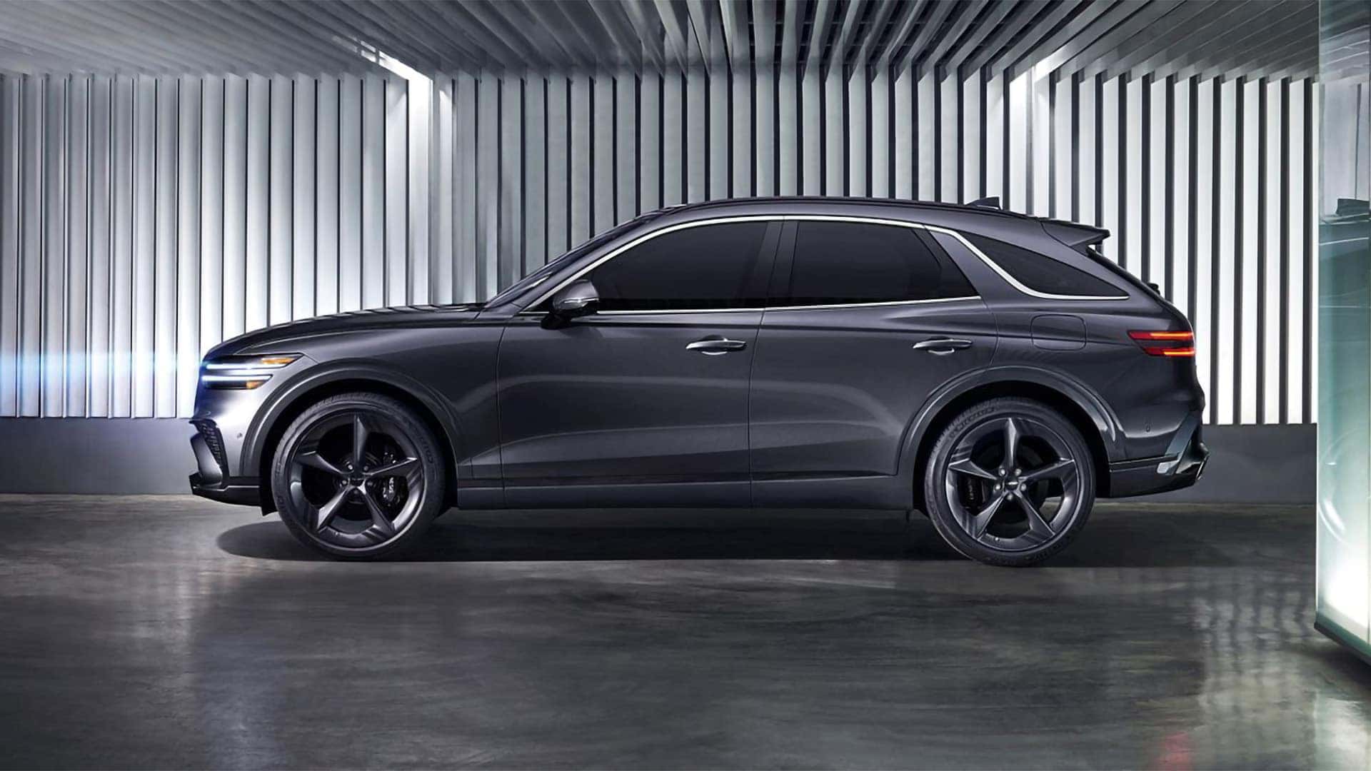 2026 Genesis GV70 front lighting detail with illuminated Two-Line LED headlamps and daytime running lights