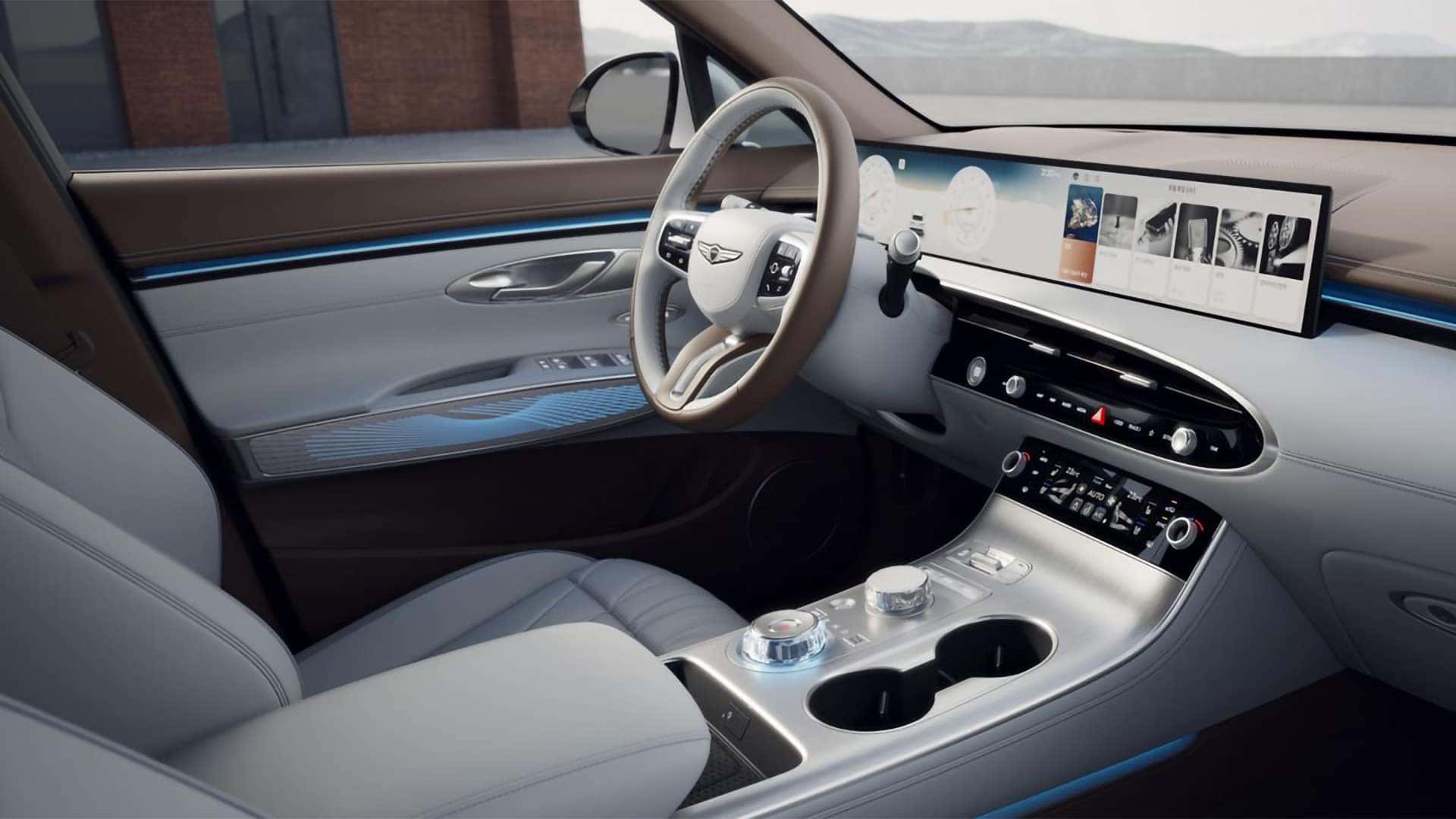 2026 Genesis GV70 interior with curved OLED display, center console controls, and ambient lighting accents